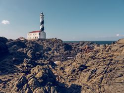 lighthouse located on rocky coastline of ocean