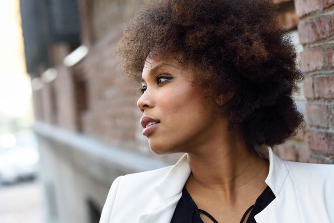 Close up of side of female looking away from camera with serious expression with space for text