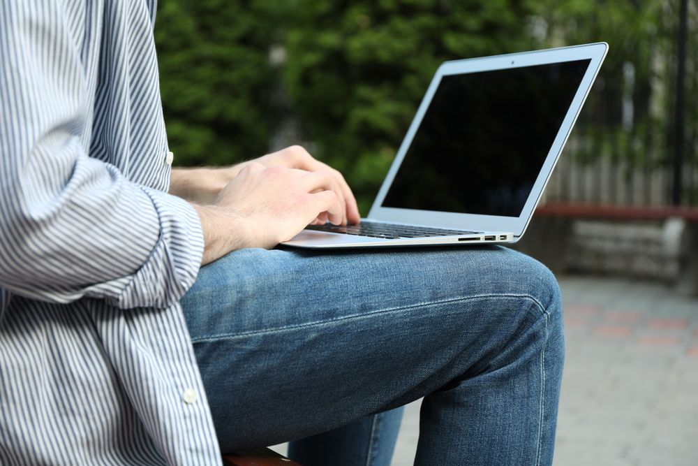 Young student working in a laptop outdoor. Study. University