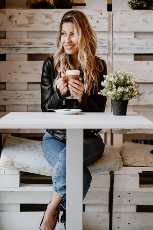 Woman drinking coffee from a glass