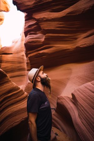 Bearded traveler looking at ravine walls