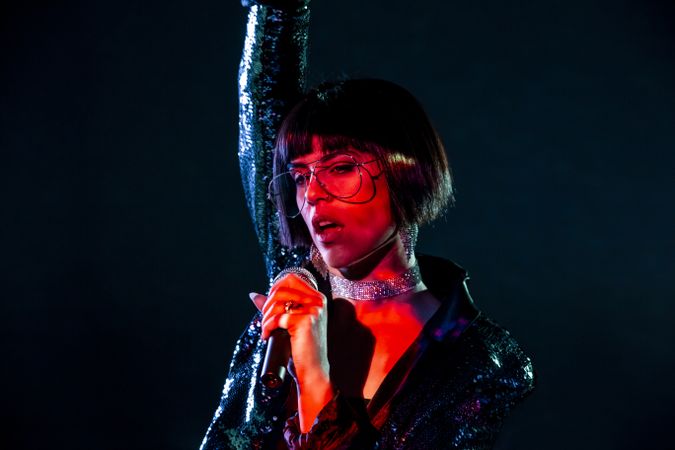 Stylish woman singing on stage