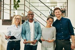 Multi-ethnic group of colleagues in business casual picture in a bright office
