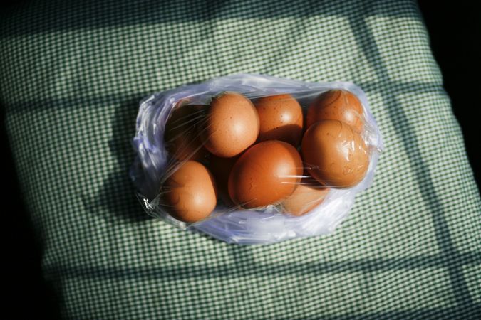 Top view of eggs wrapped in plastic