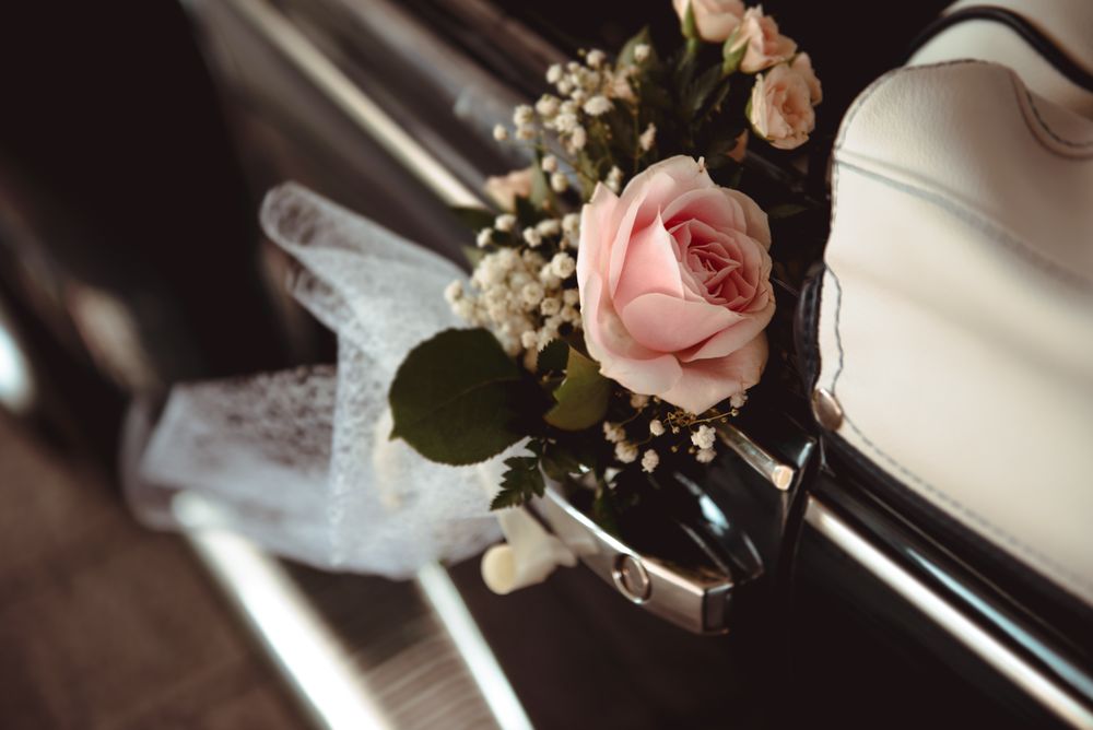 Pink flower on handle of retro car