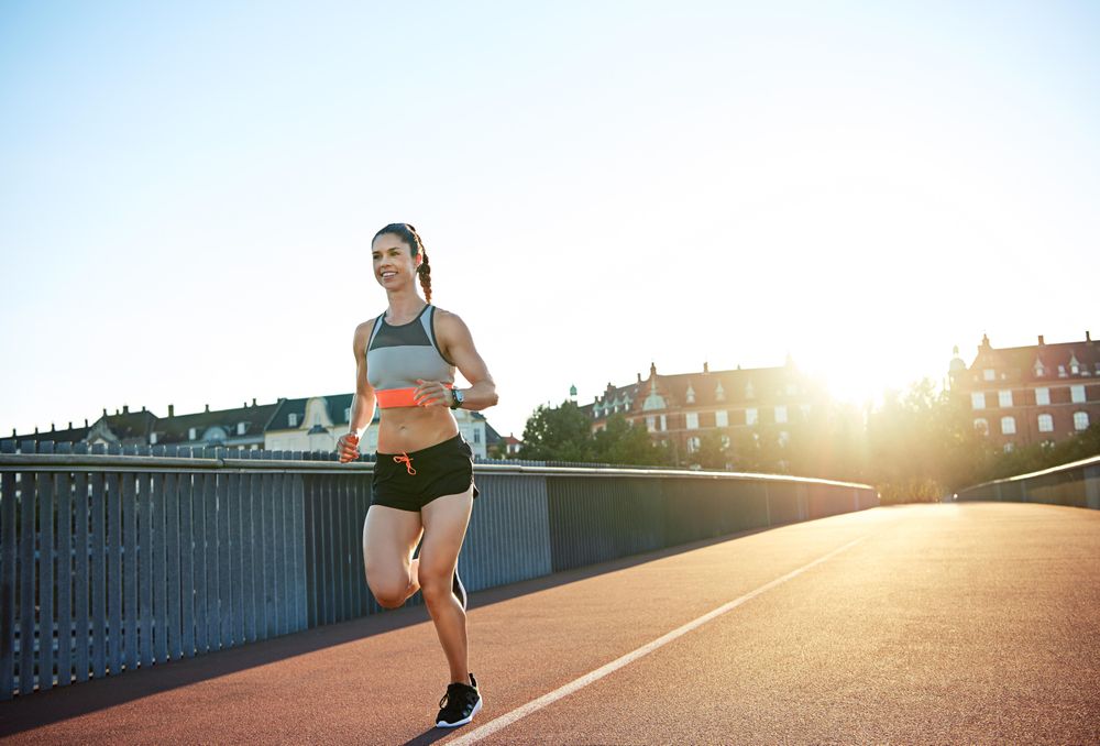 Smiling fit woman on her morning run