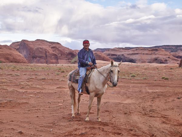 Navajo man sitting on horse in Monument Valley