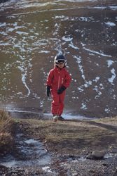 Boy walking in mountains on spring day