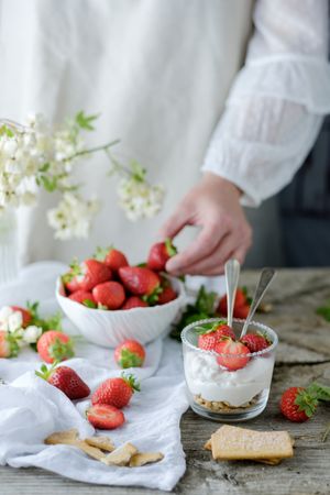 Confectioner cooking dessert of ripe strawberries