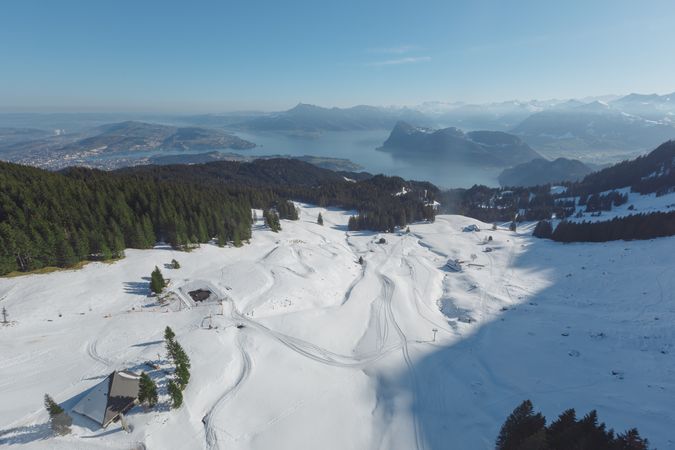 Snowy ski resort on mountains in sunlight