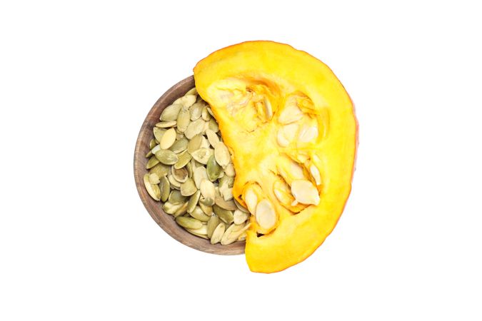 Fall season food - pumpkin seeds, isolated on light background