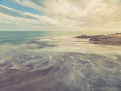 Rocky seashore under blue sky