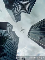 Low angle view of airplane above skyscrapers in Bugis, Singapore bGX7X0