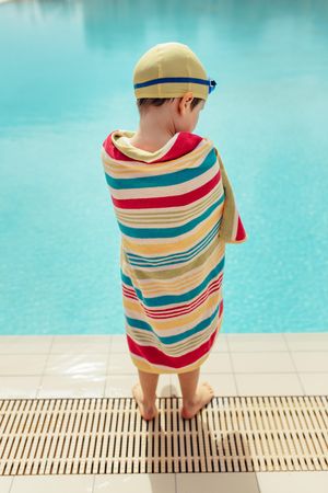 Young boy drying off from swimming lesson