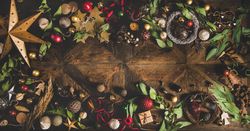 Holiday decorations of stars, baubles, leaves, and ribbon, with copy space