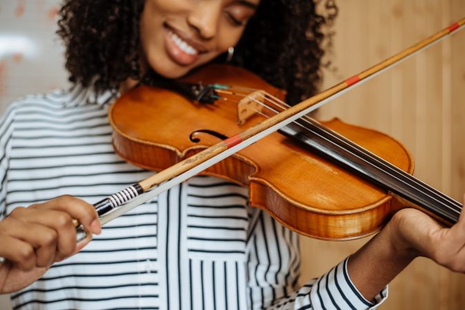 Woman playing violin in studio