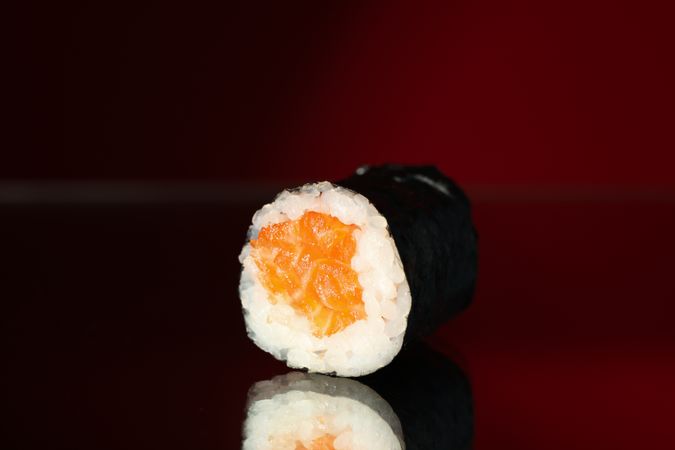 Delicious sushi roll on mirror background, close up. Japanese food