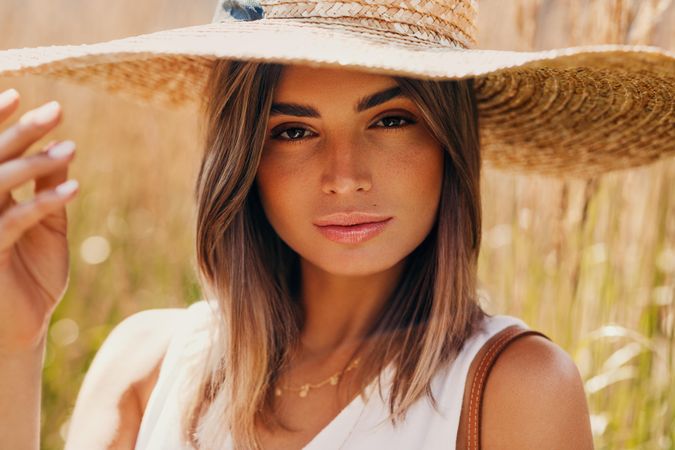 Woman in field with straw hat