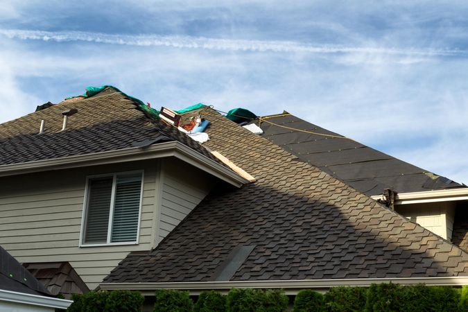 Home roof being replaced with new composite shingles