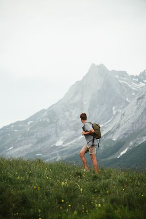 Unrecognizable man with backpack hiking in Pyrenees mountains