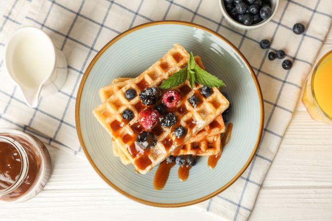 Composition of breakfast with belgian waffles, top view