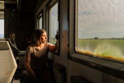 Military woman travelling looking out van window