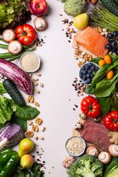 Assortment of healthy food ingredients for cooking with copy space in center of picture, vertical