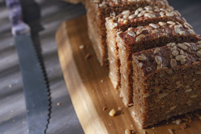 Sliced wholegrain bread on wooden cutting board
