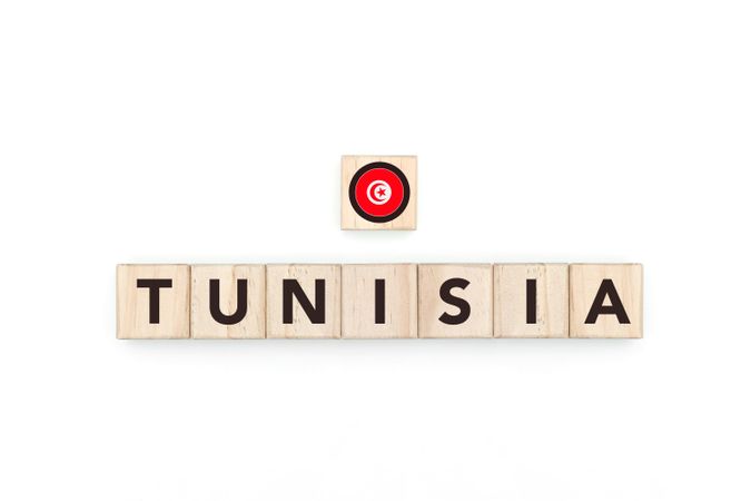 Wooden blocks bearing the name and flag of Tunisia. Tunisian and African Culture, national identity, travel, and geography in a copy space design.