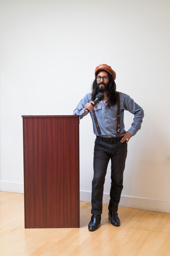 Man addressing the room next to a podium