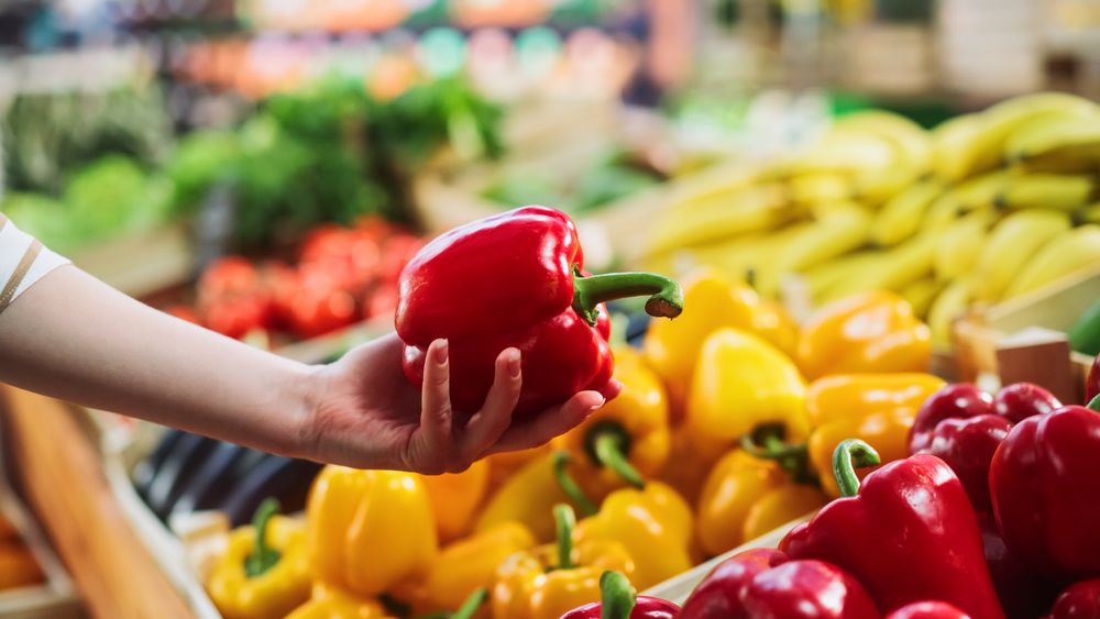 Woman Buying Fresh Vegetables from a Local Farm Market Stall.