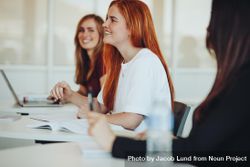 Student with beautiful red hair sitting as desk in classroom 56nWd5