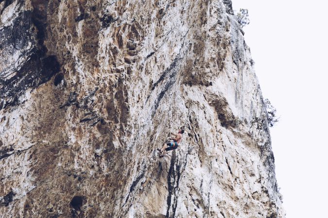 Anonymous man climbing rock
