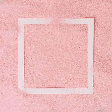 Pink sand with paper square outline