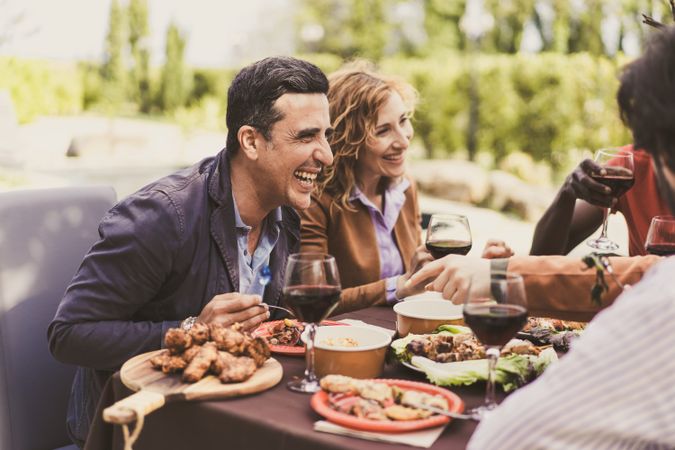 Happy beautiful cheerful people celebrating and eating together