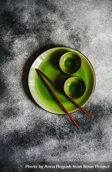 Green plate with chopsticks and cups bDXoVb
