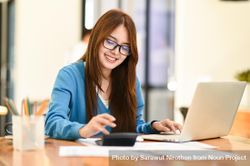 Woman with glasses working happily at home 5pzqeb