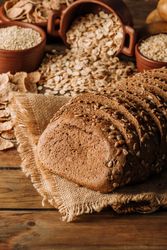 Freshly baked rye bread on napkin on table