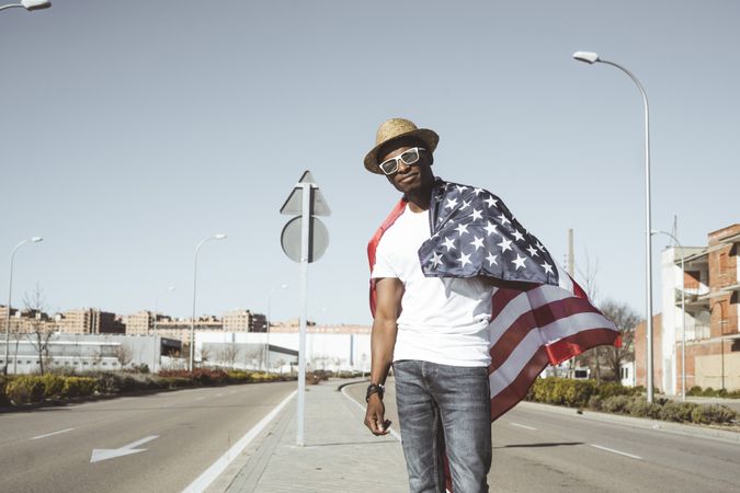 Happy black man with flying American flag