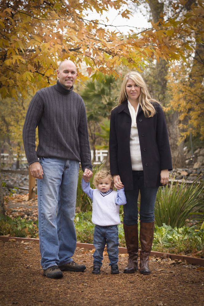 Parents and Child Walking in Park