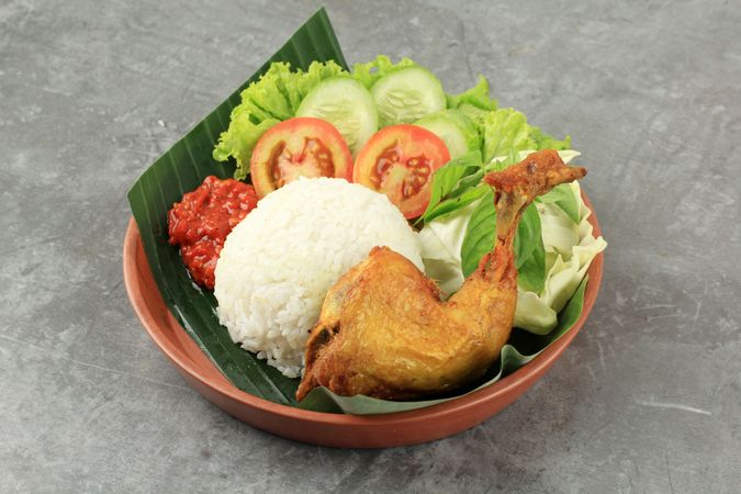 Pecel ayam, fried chicken with rice and spicy sauce