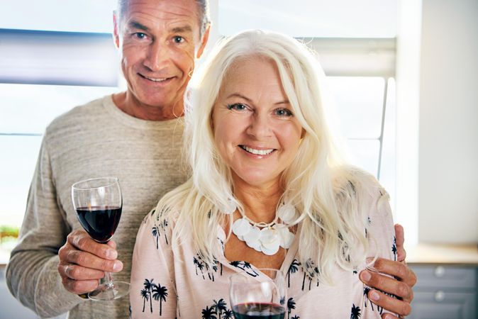 Happy older couple with red wine