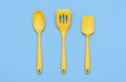 Yellow kitchenware set isolated on blue background above view