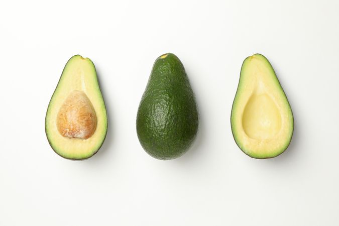 Flat lay with avocado on plain background, top view
