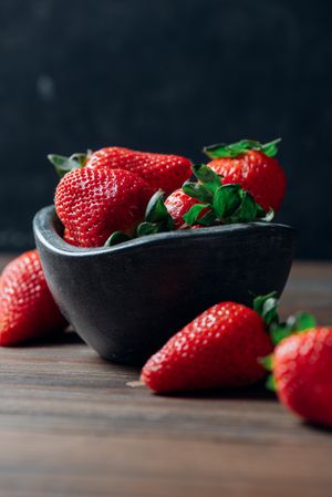 Fresh ripe strawberries in concrete bowl
