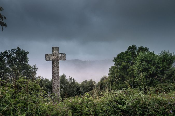 Cross tombstone on overcast day