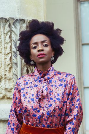 Portrait of Black woman with afro hair wearing pink floral shirt