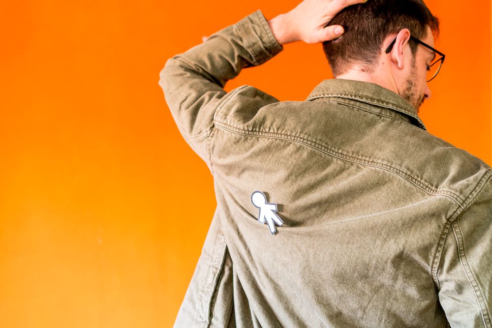 man with funny paper toy on jean jacket