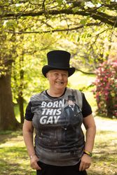 Woman in top hat in green park