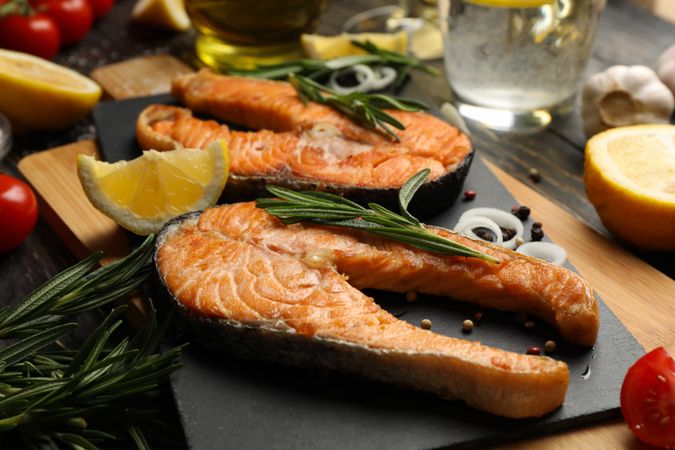 Composition with tasty grilled salmon on wooden background, close up